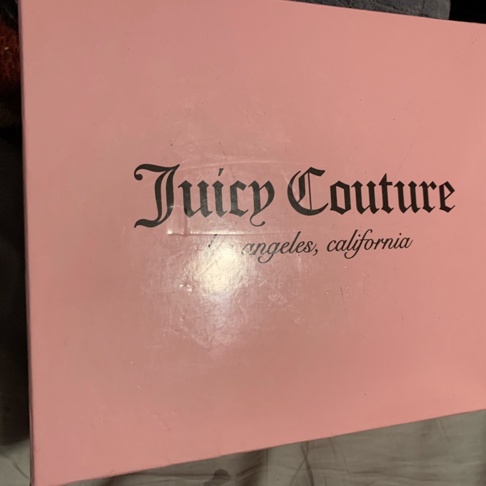 Juicy Couture mini backpack with pink flower design.